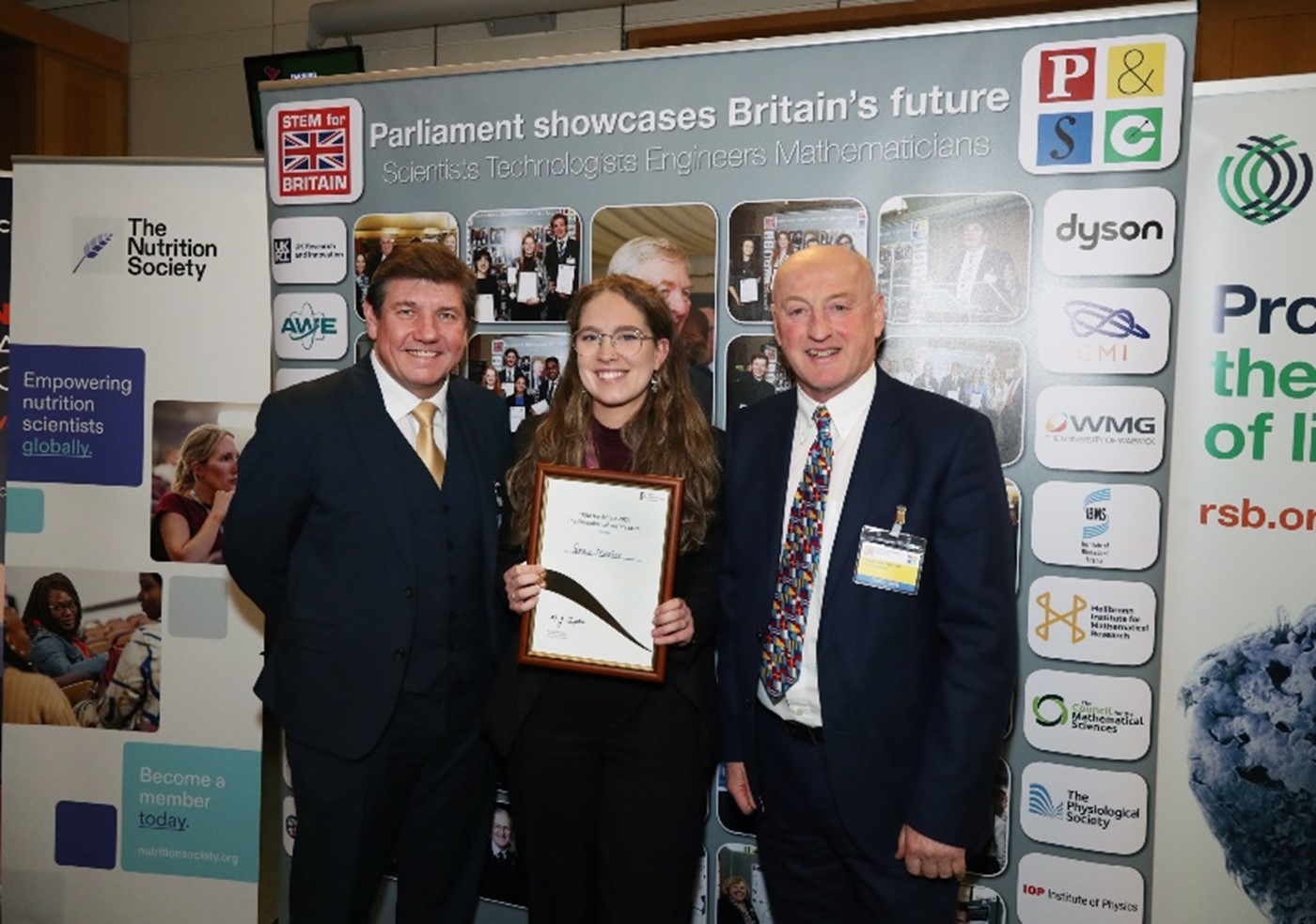 Grace Meaker, The Physiological Society Prize winner at STEM for Britain with Stephen Metcalfe and Professor Mike Tipton